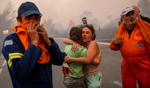 Emergency service personnel work to rescue people during wildfires in Varnavas, north of Athens, August 11, 2024. (AFP)