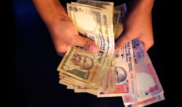 An Indian counts currency notes of 1000 and 500 denomination in New Delhi, India, Tuesday, Nov. 8, 2016. (AP)