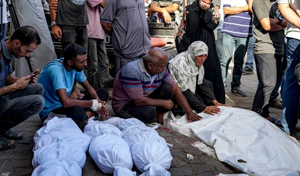 Palestinians mourn for relatives killed in the Israeli bombardment of the Gaza Strip, at a hospital in Deir al-Balah, Saturday, Aug. 10, 2024 (AP Photo/Abdel Kareem Hana)