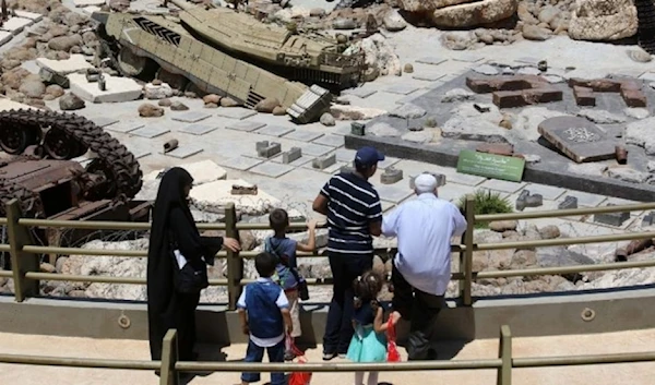 Visitors look at tanks left behind in Lebanon by Israeli forces as they visit the 'Tourist Landmark of the Resistance' war museum in Mlita (aka Mleeta) in southern Lebanon on July 12, 2016 (AFP)