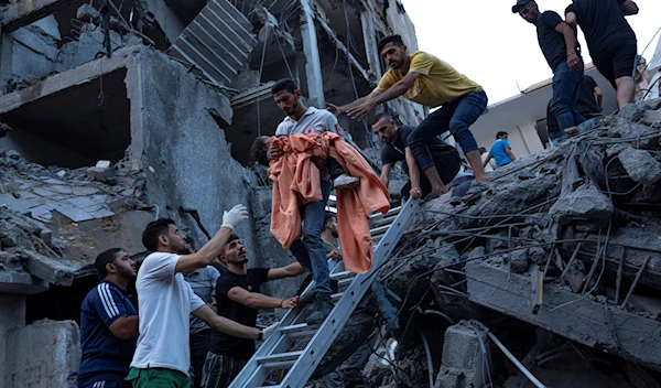 Palestinians rescue a young girl from the rubble of a destroyed residential building following an Israeli airstrike on Gaza, October 10,2023. (AP)