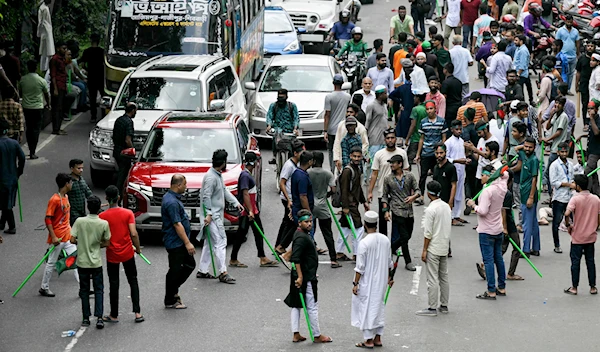 Bangladeshi protester armed with bamboo sticks roam Dahka streets