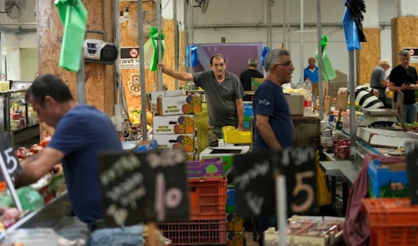 Vendors sell fruit and vegetables in a market in Haifa, 'Israel', Monday, Aug. 5, 2024. (AP)