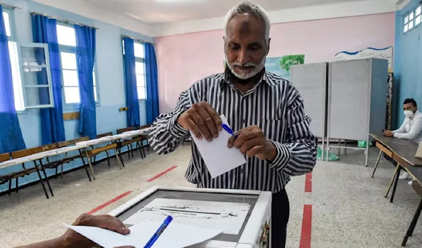 A voter casts his ballot in Bouchaoui, on the outskirts of Algiers, during the 2021 parliamentary election. (AFP)