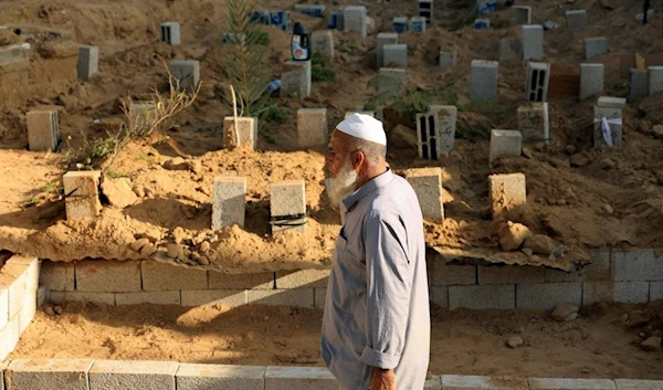 Palestinian gravedigger Saadi Hassan Barakeh say he has been burying the dead for 28 years, but has never been so busy amid the Gaza war. (AFP)