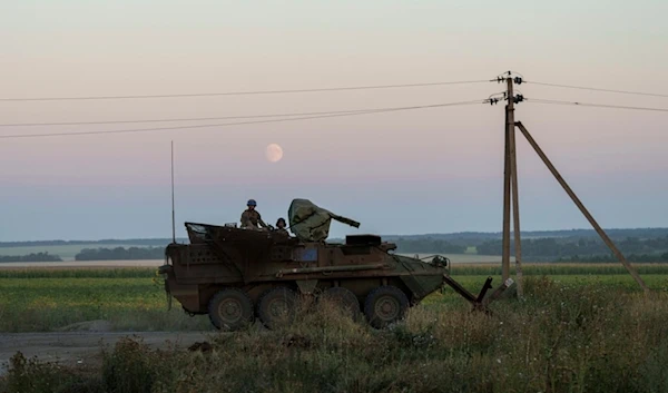 Ukrainian servicemen ride atop on an armored personnel carrier after returning from Russia near the Russian-Ukrainian border in Sumy region, Ukraine, on Saturday, Aug. 17, 2024. (AP)