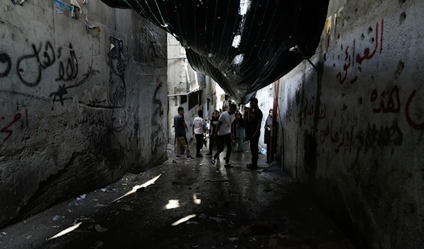 Palestinians look at the damage following an Israeli airstrike in the Balata refugee camp, near the West Bank city of Nablus, Saturday, July 27, 2024.