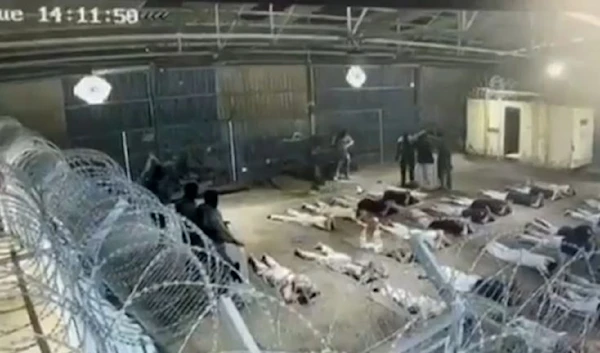 Palestinian prisoners forced to lay on the ground at the Sde Teiman concentration camp (X/TheCradleMedia)