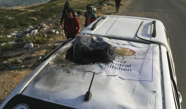 Palestinians inspect a vehicle with the logo of the World Central Kitchen wrecked by an Israeli in Deir al-Balah, Gaza Strip, Tuesday, April 2, 2024. (AP)