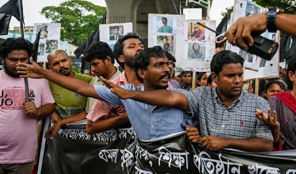 People take part in a protest march against the mass arrests and killings of protesters during violence in Dhaka, Bangladesh. (AFP - Getty Images)