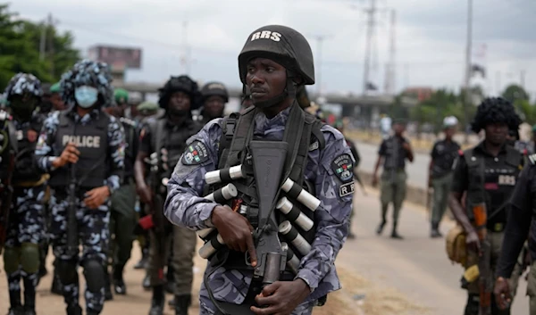 Policemen patrol during a protest against the economic hardship on the street in Lagos, Nigeria, Friday, Aug 2, 2024. (AP)