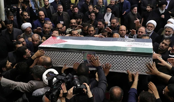 People carry the coffin of Hamas leader Ismail Haniyeh who was assassinated by 'Israel' on Wednesday, during his funeral ceremony at the Tehran University campus, in Tehran, Iran, Aug. 1, 2024. (AP)