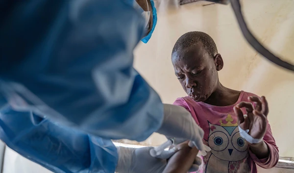 A health worker attends to a mpox patient, at a treatment centre in Munigi, eastern Congo, August 19, 2024. (AP)