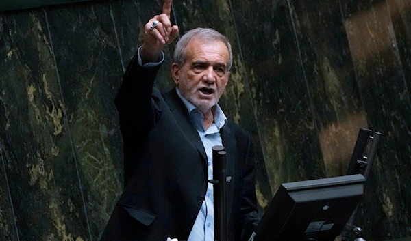 Iranian President Masoud Pezeshkian speaks in an open session of parliament to debate on his proposed ministers, in Tehran, Iran, Saturday, Aug. 17, 2024. (AP)