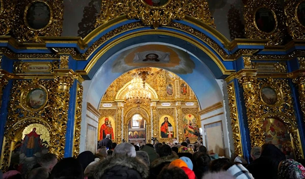 People attend the Christmas service in the Assumption Cathedral in Lavra, the Monastery of the Caves, Kyiv, Ukraine, Saturday, Jan. 7, 2023. (AP)