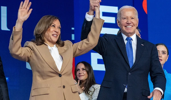 Democratic presidential nominee Vice President Kamala Harris, left, clasps her hand in the air with President Joe Biden at the Democratic National Convention, Aug. 19, 2024, in Chicago. (AP)