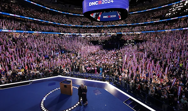 Democratic vice presidential nominee Minnesota Gov. Tim Walz embraces his wife Gwen after speaking on the third day of the Democratic National Convention in Chicago, Aug. 21, 2024. (Pool/AP)