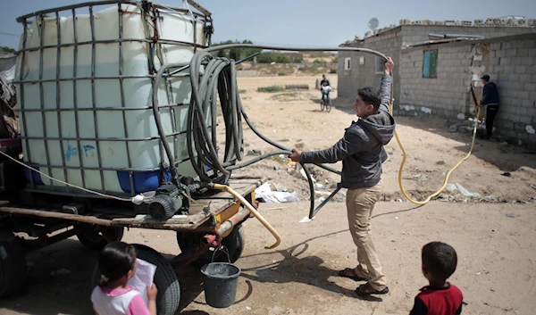 A Palestinian man sells drinking water in Khan Younis refugee camp, southern Gaza Strip on April 16, 2016. (AP)