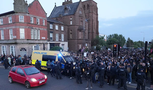 Counter protesters block a road in Liverpool, Wednesday, Aug. 7, 2024 ahead of anti-immigration groups planning to target dozens of locations throughout the country following a week of rioting (AP)