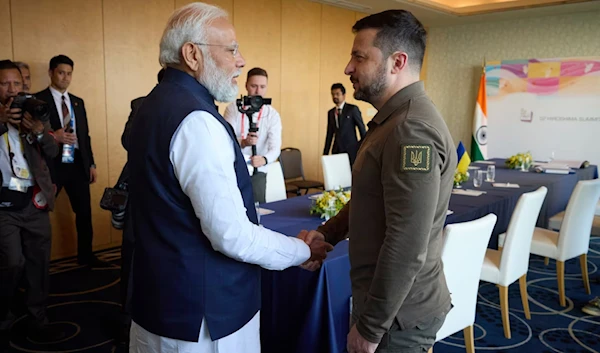 This handout photograph taken and released by the Ukrainian Presidential Press Service on May 20, 2023, shows Ukraine's President Volodymyr Zelensky meeting India's Prime Minister Narendra Modi in Japan. (AFP)