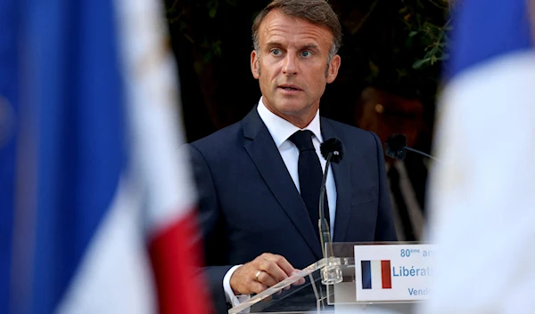 French President Emmanuel Macron speaks during a ceremony in Bormes-les-Mimosas, south-eastern France, Saturday, Aug. 17, 2024 (Poo/AP)