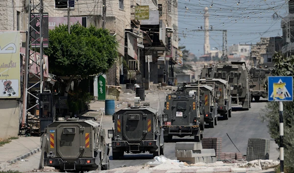 A column of Israeli Army armored vehicles leave following a military operation in the West Bank town of Tubas, Wednesday, Aug. 14, 2024.