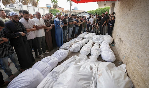 Palestinian mourners pray at the funeral for more than 15 people, including several children and women, killed in an Israeli strike, at Al-Aqsa Martyrs Hospital in Deir al-Balah, Gaza Strip, Aug. 17, 2024. (AP)