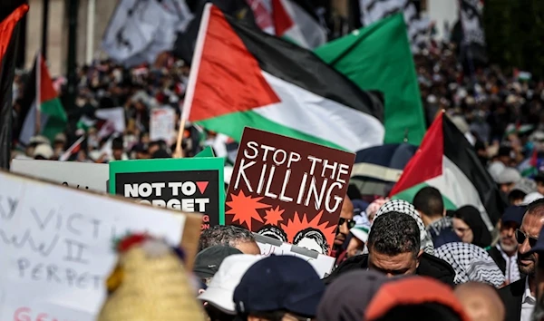 Protesters lift placards and flags of Palestine during a demonstration in Rabat on February 11, 2024. (AFP)