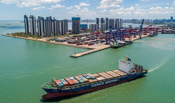 A cargo ship loaded with containers leaves a port in Haikou, Hainan province, southern China, May 17, 2021. (AFP)