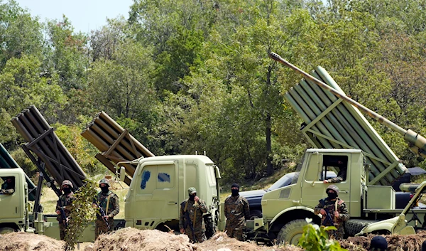 Hezbollah fighters stand next to multiple rocket launchers during a training exercise in southern Lebanon, Sunday, May 21, 2023. (AP)