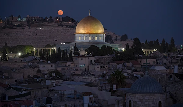 The supermoon rises behind the Dome of the Rock shrine at the al-Aqsa Mosque compound in the Old City of occupied al-Quds, occupied Palestine, August 19, 2024 (AP)