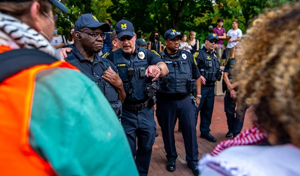 An image showing US police officers on the campus of the University of Michigan just before arresting a pro-Palestine protestor on August 28, 2024. (Social media)