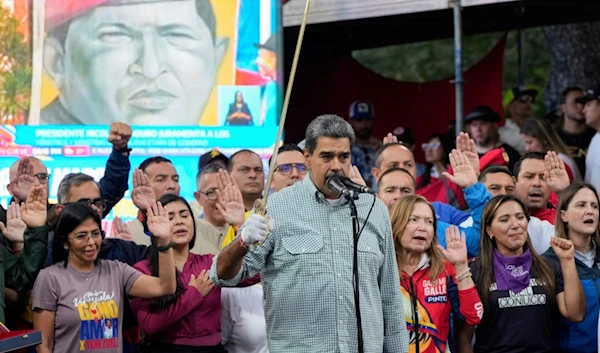 Venezuela's President Nicolás Maduro brandishes a sword as his new Cabinet takes the oath of office, at the presidential palace in Caracas, Venezuela, Wednesday, Aug. 28, 2024. (AP)