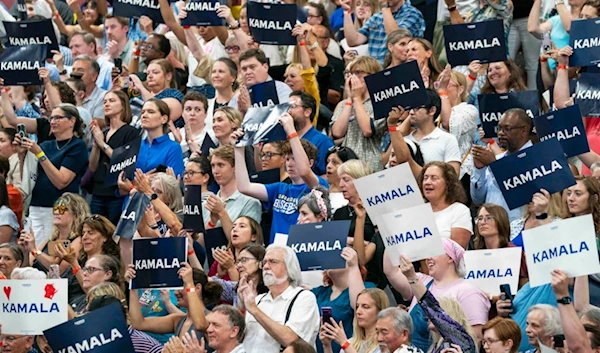 Supports hold up signs in support of Vice President Kamala Harris at an event, July 23, 2024, in West Allis, Wis. (AP Photo/Kayla Wolf, File)