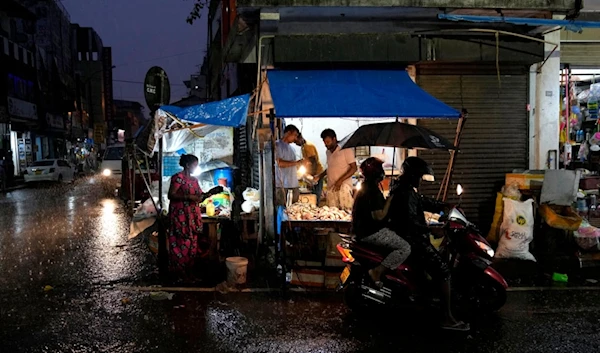 Roadside vendors wait for customers at a market place in Colombo, Sri Lanka, Friday, Dec. 8, 2023. (AP)