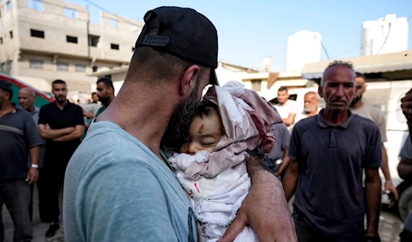 Relatives mourn a child killed in the Israeli bombardment of the Gaza Strip at a hospital in Deir al-Balah, Friday, Aug. 30, 2024 (AP Photo/Abdel Kareem Hana)