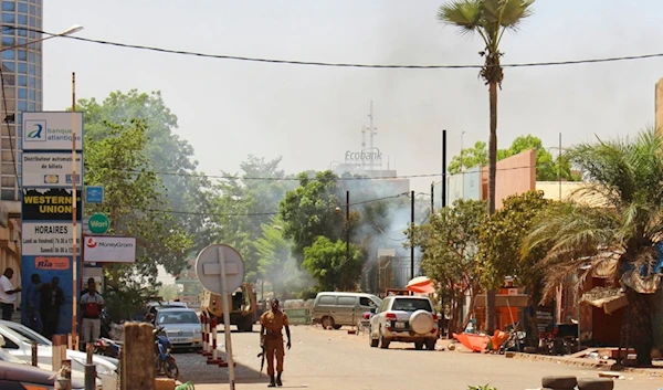 A soldier walks near the rear of the Army Headquarters in central Ouagadougou, Burkina Faso, Friday March 2, 2018. (AP)