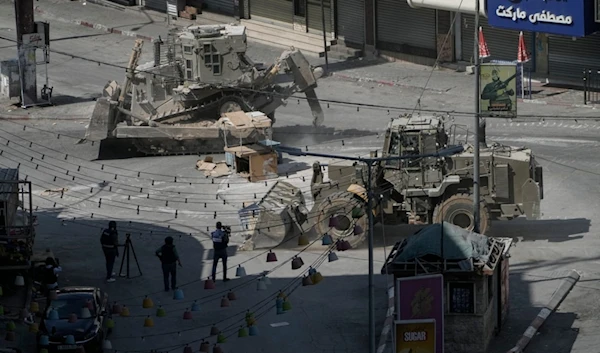 Israeli bulldozers move on a street during a military operation in the West Bank city of Jenin, Saturday, Aug. 31, 2024. (AP Photo/Majdi Mohammed)