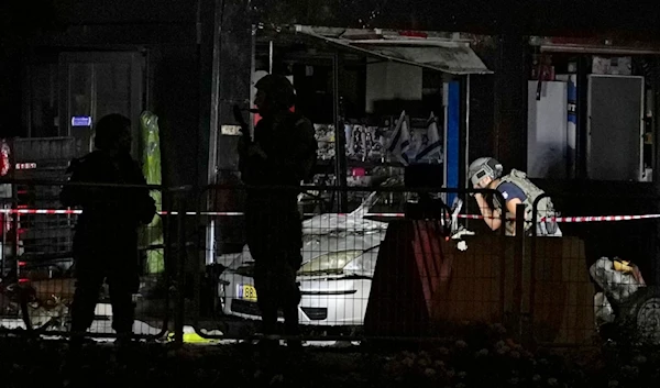 Israeli security forces examine a car after an explosion at a gas station in the West Bank settlement of Gush Etzion, Saturday, Aug. 31, 2024. (AP)