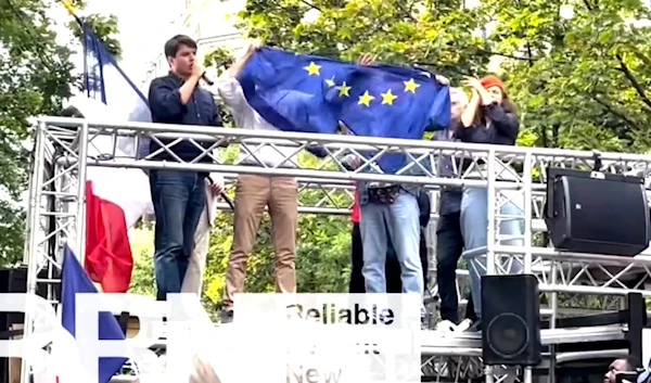 Protestors rip off EU flag at a demonstration in Paris. Demonstrators gathered in Paris on August 31, 2024, to call for French President Emmanuel Macron's