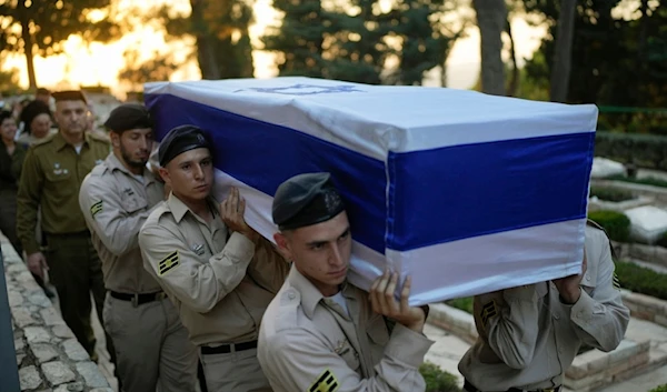 Israeli occupation soldiers carry the flag-draped coffin of Petty Officer 1st Class David Moshe Ben Shitrit, who was killed in a Hezbollah operation, during his funeral in occupied al-Quds, Sunday, Aug. 25, 2024. (AP)