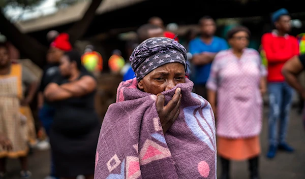 People living near the traditional medicine market wait to receive food baskets from private donors, Monday, April 13, 2020 downtown Johannesburg. (AP)