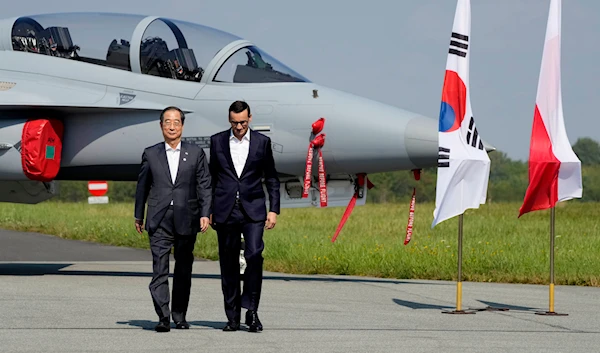 South Korean Prime Minister Han Duck-Soo, left, and his Polish host, Prime Minister Mateusz Morawieckiat an air base in Minsk Mazowiecki, eastern Poland, Wednesday, Sept. 13, 2023. (AP)