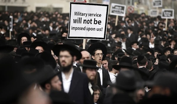 Hundreds of ultra-Orthodox Israelis protesting against plans to make them undergo military service in occupied al-Quds on March 2,2024. (AFP)