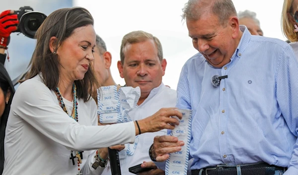 Opposition leader Maria Corina Machado, left, and opposition candidate Edmundo Gonzalez hold up vote tally sheets during a protest against the official presidential election results, Venezuela, July 30, 2024. (AP)