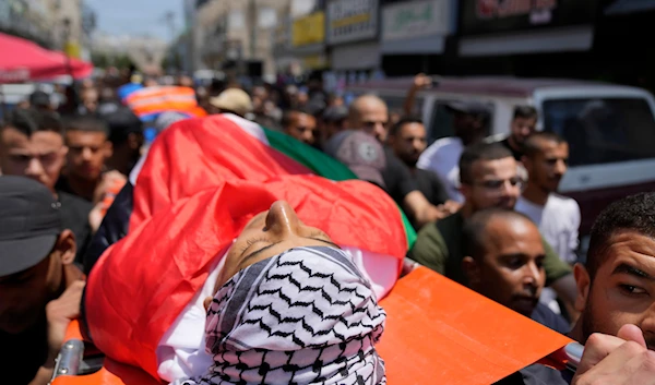 Mourners carry the body of Palestinian Yazan Abdo, 30 during his funeral in the occupied West Bank refugee camp of Tulkarm, July 24, 2024 (AP)