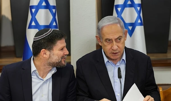 Israeli Prime Minister Benjamin Netanyahu,right,speaks with Minister of Finance Bezalel Smotrich during the weekly cabinet meeting with security Ministry in Tel Aviv on Sunday January 7,2024. (Pool Via AP)