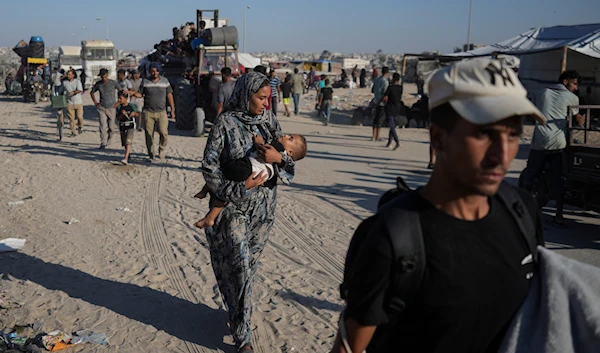 Palestinians flee the Khan Younis area of the Gaza Strip, following Israeli military evacuation orders, saying the IOF would soon operate there, Thursday, August 8, 2024 (AP)