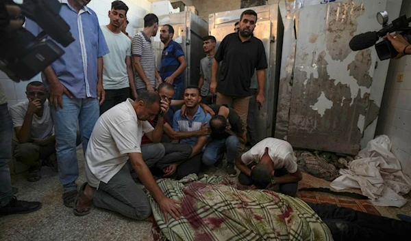 Palestinians mourn the victims of an Israeli airstrike in Deir al Balah, Gaza Strip, Tuesday, Aug. 6, 2024. (AP)