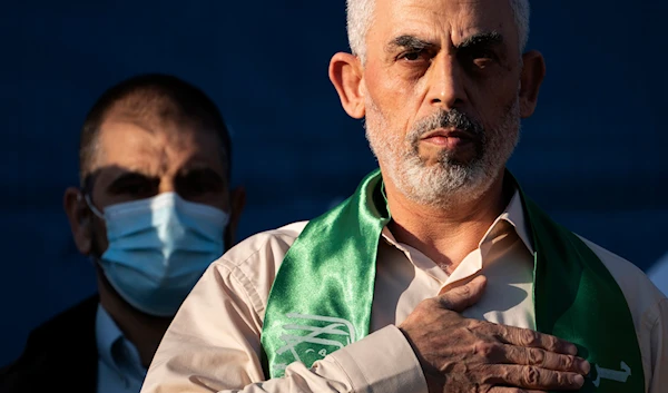 Yahya Sinwar, Palestinian leader of Hamas in the Gaza Strip, places his hand over his heart on stage after greeting supporters at a rally, Monday, May 24, 2021, in Gaza City, the Gaza Strip (AP)